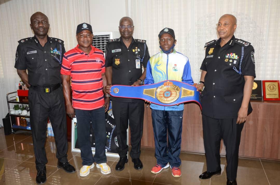 IGP USMAN IN GROUP PHOTOGRAPH WITH PC MARY YETUNDE AINA, THE COACH AND OTHER SENIOR POLICE OFFICERS.